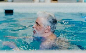 person swimming freestyle in a pool a weight-loss workout