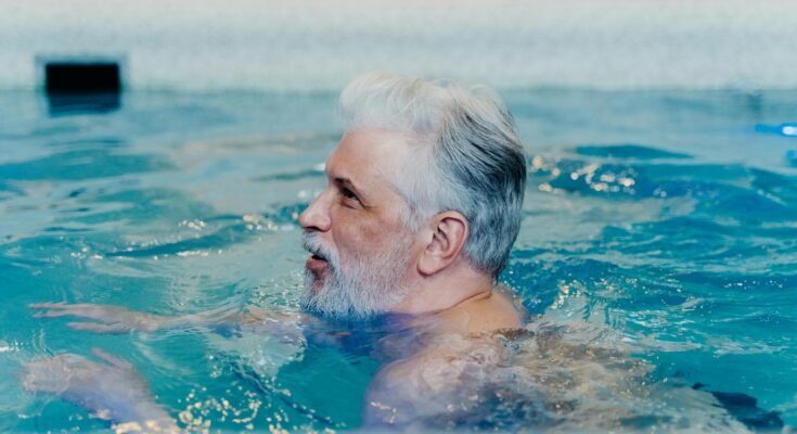 person swimming freestyle in a pool a weight-loss workout